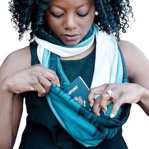 a woman putting a passport in a scarf