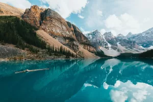 a lake with mountains and trees in the background
