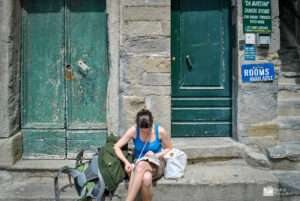 a woman sitting on a stone step