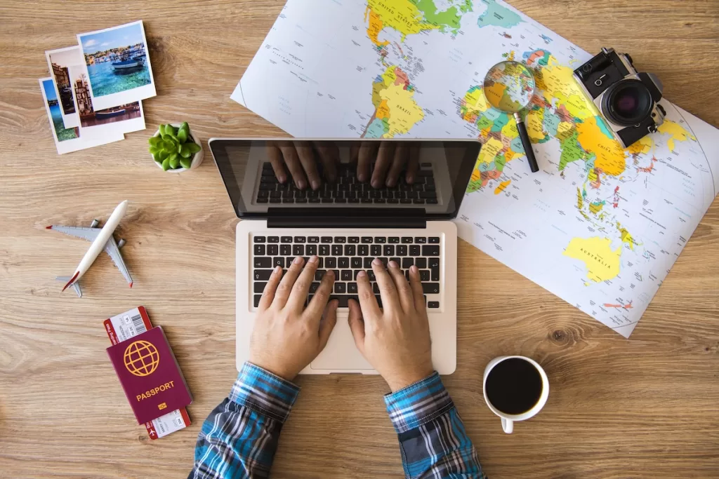 hands on a laptop making a reservation for travel