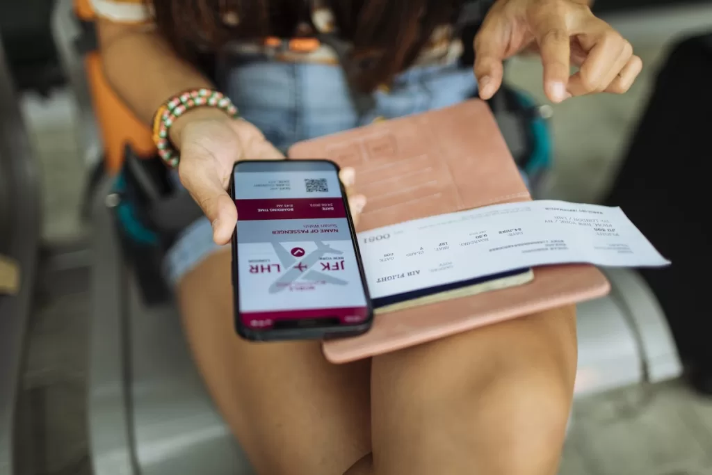 a person holding a phone and a passport