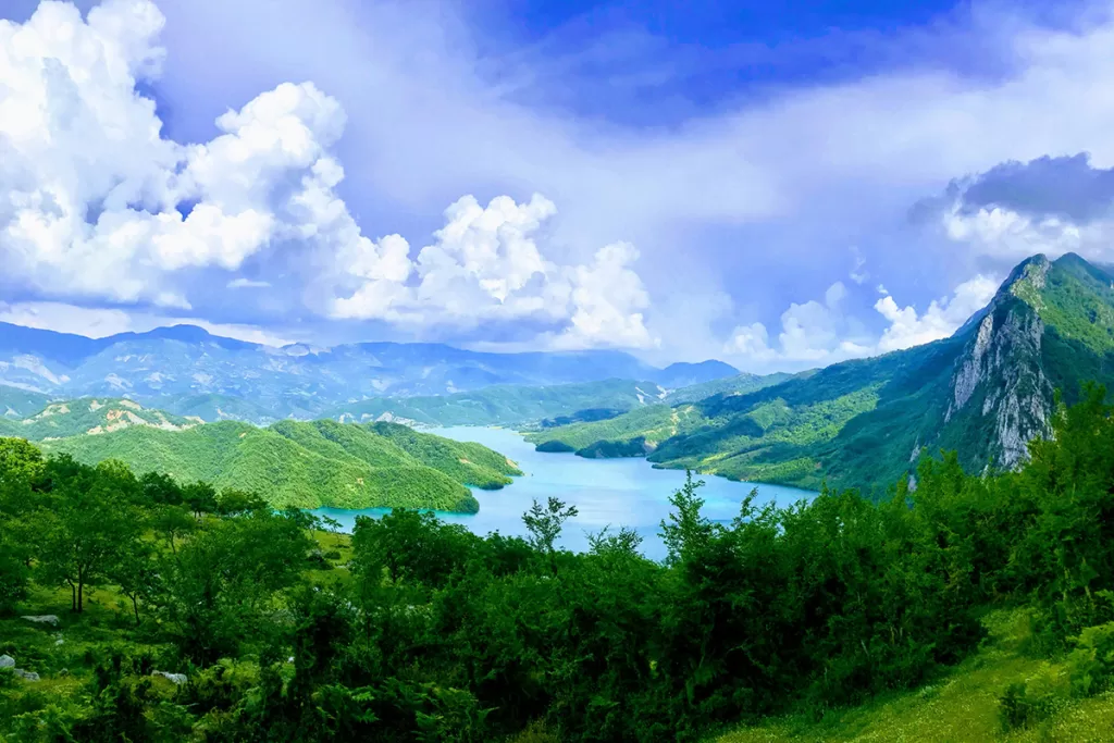 albania-digital-nomad-visa-bovilla-reservoir a lake surrounded by trees and mountains