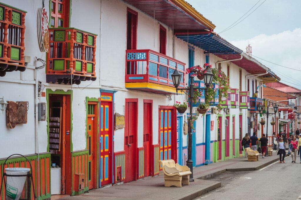 colorful buildings with a street and a people walking