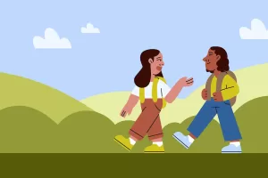 Two friends talk while walking to school surrounded by nature outside