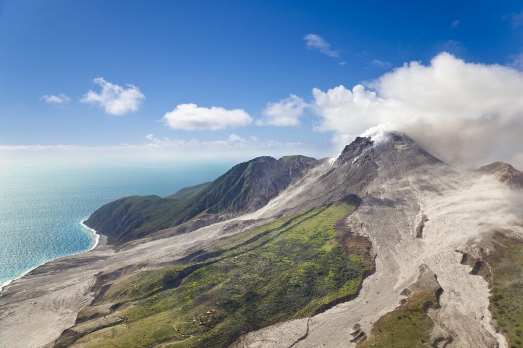 Soufriere Hills Volcano, Montserrat a mountain with smoke coming out of it