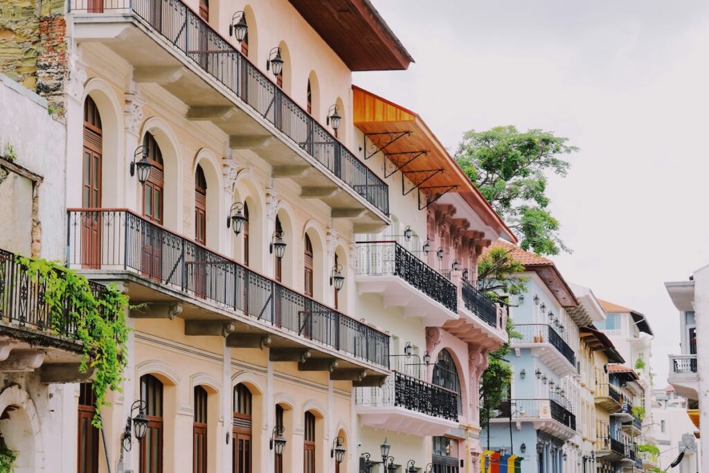 pastel building facades with balconies and plants