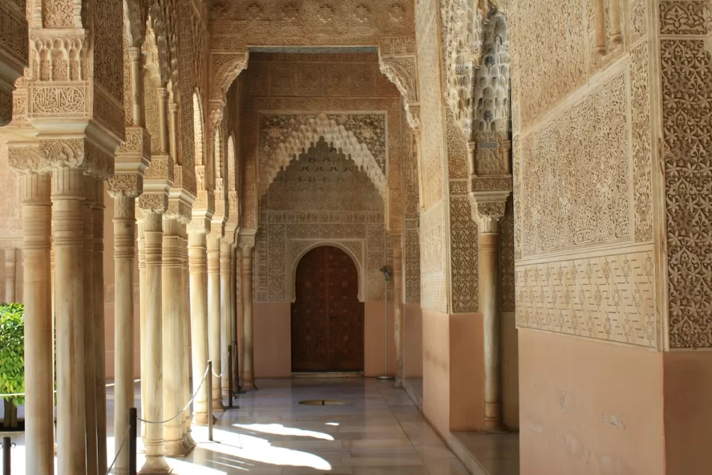 a portico with ornate carvings in the Alhambra in Spain