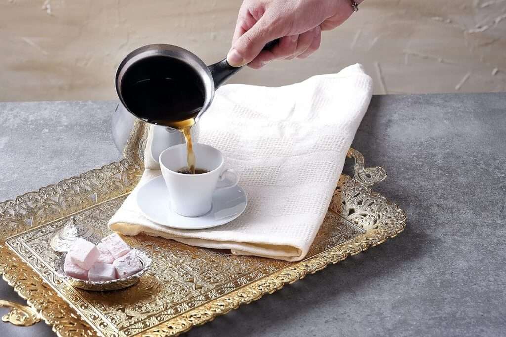 Turkish coffee being served in a traditional Turkish coffee pot